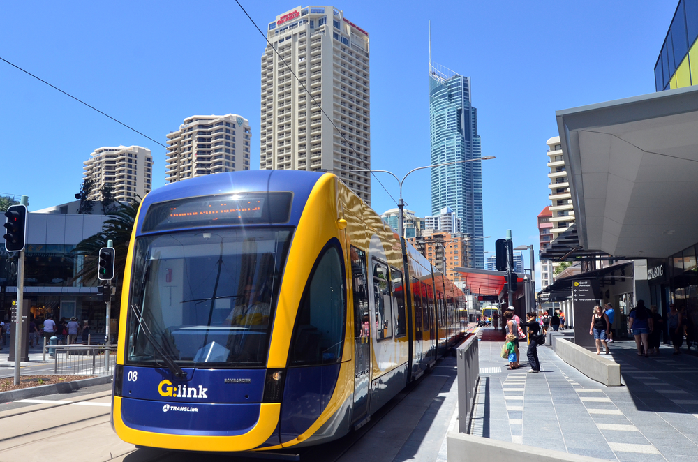 GOLD COAST, AUS - OCT 29 2014:Gold Coast Light Rail G cross over Sundale Bridge and Southport skyline in Gold Coast Queensland, Australia.The line opened on July 2014 and it 13 Km (8.1 mi) long.